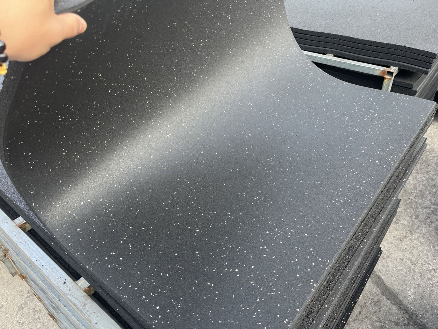 Car trunk with a black rubber mat on a concrete surface