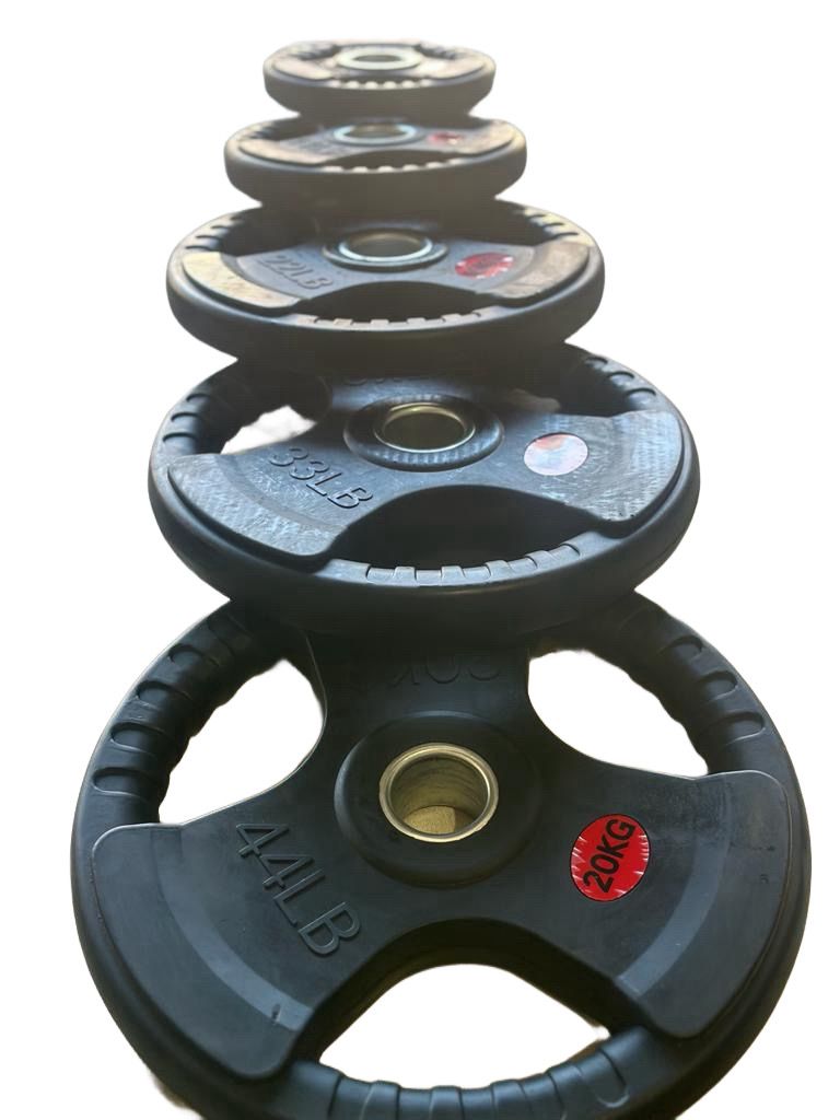 Set of weight plates with visible weight markings on a white background