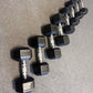 Set of hexagonal dumbbells on a gray floor