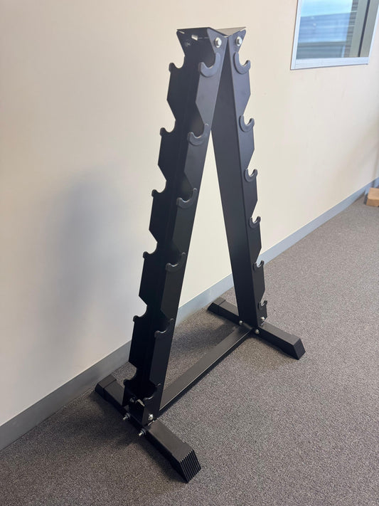 Black metal weight plate rack against a white wall.