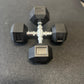 Pair of black dumbbells with '5 KG' marking on a gray surface