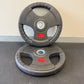Two gray weight plates with red logos on a gray surface.